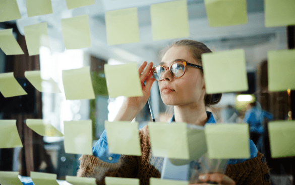 woman using sticky notes to plan strategy